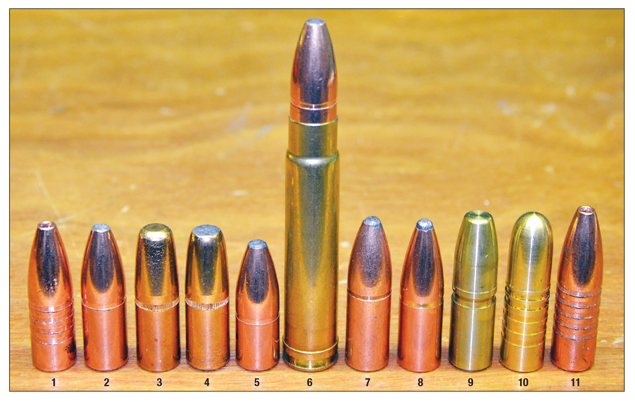 When handloading the .416 Taylor, bullet length is important because the longer the bullet, the more it encroaches on the rather short powder cavity. The bullets shown to the left of a loaded round are better suited than the longer bullets on the opposite side: (1) Barnes 350 TSX FB, (2) Swift 400 A-Frame, (3) Hornady 400 DGS, (4) Hornady 400 DGXB, (5) Swift 350 A-Frame, (6) Swift 400 A-Frame, (7) Federal 400 Bear Claw SP, (8) Nosler 400 Partition, (9) Nosler 400 Solid, (10) Barnes 400 Banded Solid, (11) Barnes 400 TSX FB.